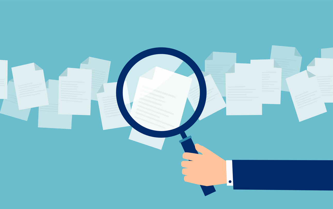 Employer with magnifying glass exploring application papers